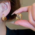 Interlocking Double Hoop Clip On Earrings in Gold and Silver view 4