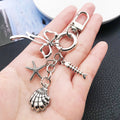 Three Silver Tone Bow Shell and Starfish Clasp Keychains view 3
