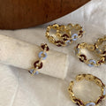 Gold Tone Burgundy And Pale Blue Interlocking Ring With Crystals view 2