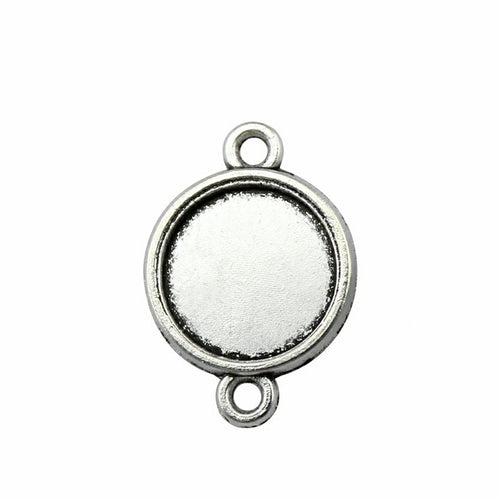 Double Loop Round Cabochon Connectors in Four Options arranged on a wood slice
