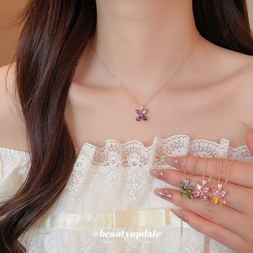 Small marquise crystal butterflies on fine rose tone chains displayed in a close product arrangement.