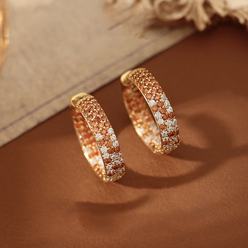 Orange Crystal Wide Hoop Earrings With Gold Tone Edges shown in worn view