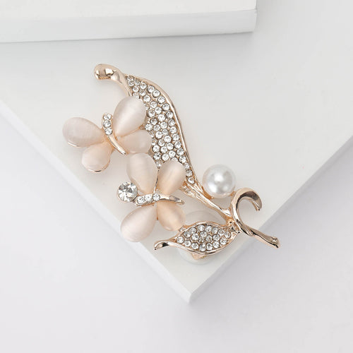 Angled close-up showing crystals on the pearl floral spray brooch
