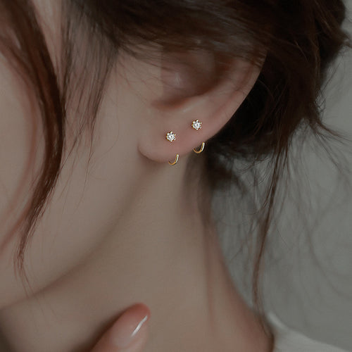 Gold Tiny Crystal Hook Earrings Polished Metal Jewelry shown on a neutral display