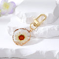 Gold Tone Druzy Style Hamsa Evil Eye and Pressed Flower Clip Keychains view 3