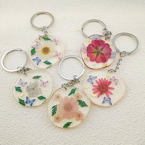 Main product view of silver Tone Round Pressed Flower Resin Clip Keychains in Five Designs