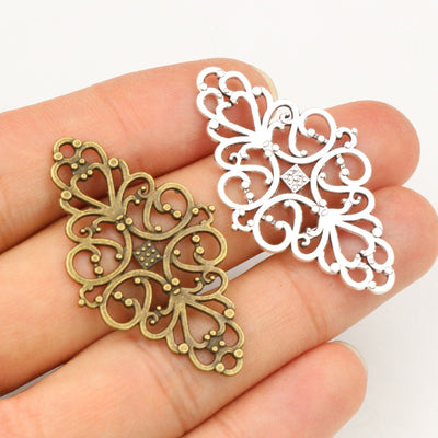 Filigree Diamond Connector Charms in Antique Bronze and Silver assortment on a plain background