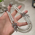 Triple Strand Faux Pearl Necklace With Crystal Bows view 4