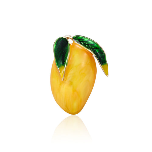 Yellow enamel mango brooch with green leaves front view on white