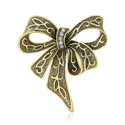 Front view of the openwork ribbon bow brooch showing an openwork ribbon bow with dark antiqued line details