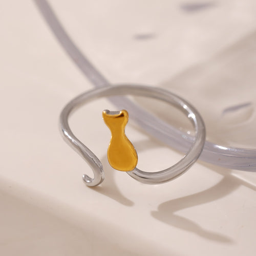 Two-tone steel band gold cat open ring on reflective surface