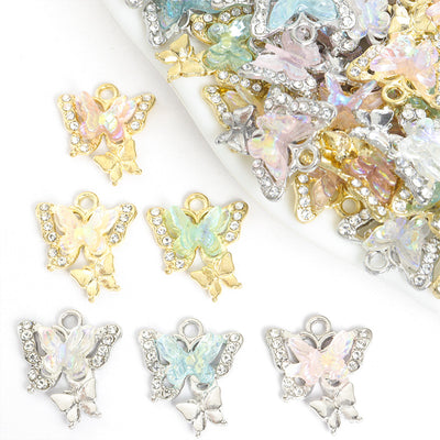 Assorted iridescent butterfly charms arranged beside a tray