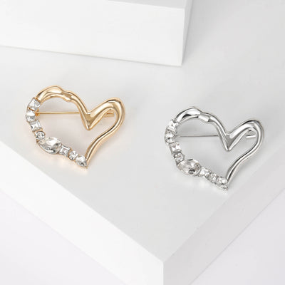 Front product view of the asymmetric double heart brooch on a light background