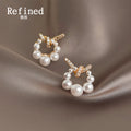 Gold Tone Clear Stone Bow And White Pearl Circle Stud Earrings view 1