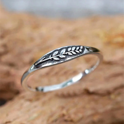 Antique silver wheat leaf embossed band ring on wood