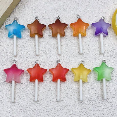 Colorful lollipop and heart charms arranged on a light background