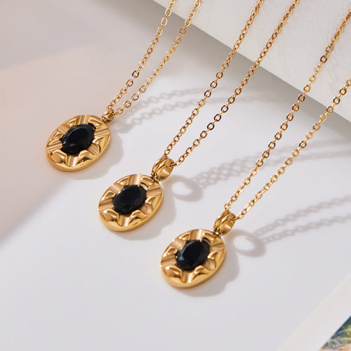 Three gold oval black zircon geometric pendant necklaces on white