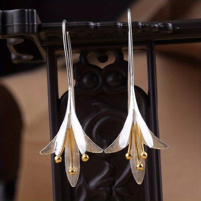 Pair of long petal tassel earrings against a dark screen