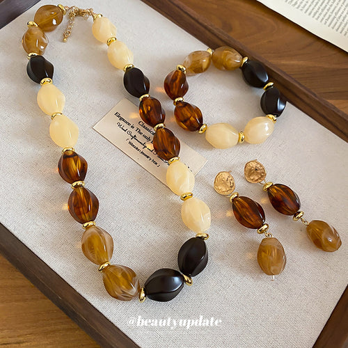 Amber cream acrylic bead necklace bracelet and earrings on tray