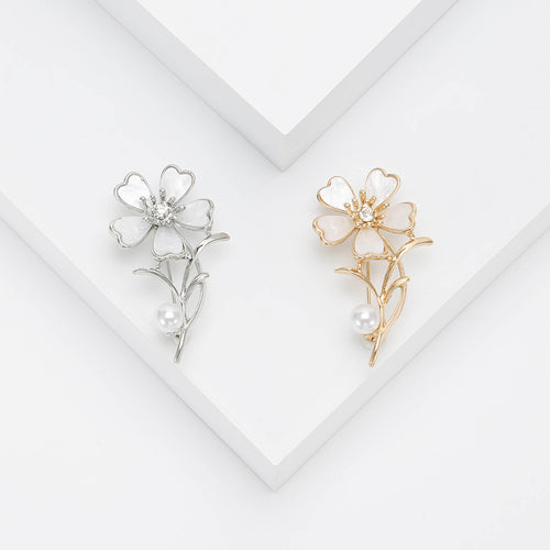 Gold flower brooch close-up petals and pearl