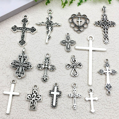 Metallic cross charms arranged on a light background