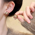 Gold Tone Red Firework Burst Stud Earrings with Clear Crystals view 1