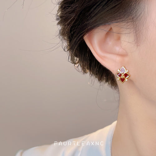 Burgundy gourd flower stud worn on ear profile