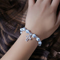 Blue Cross Bead Stretch Bracelet With Silver Tone Cross view 4
