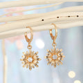 Gold Tone Huggie Earrings with Crystal Daisy and Bow Charm Drops view 5