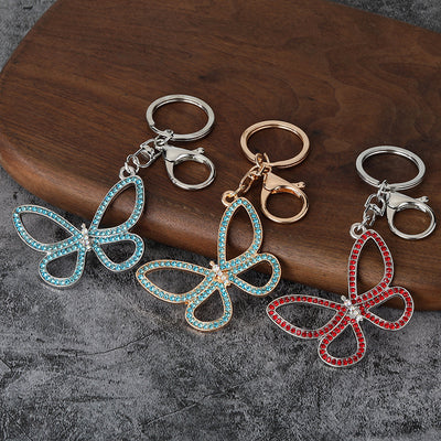 Openwork butterfly keychains in blue, clear and red stones