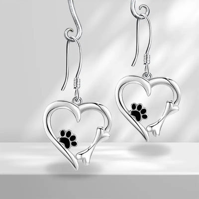 Product view showing silver-tone cat-tail heart and paw-print hook earrings