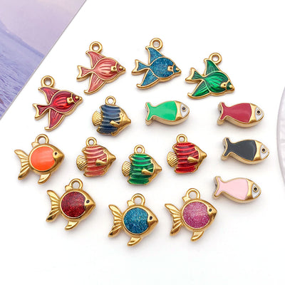 Gold-tone goldfish charms arranged on a light background