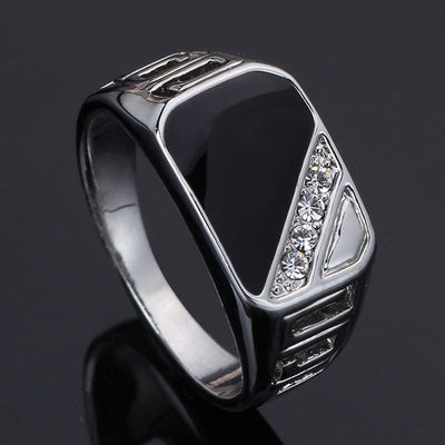 Product view showing black rectangular signet ring in three metal tones