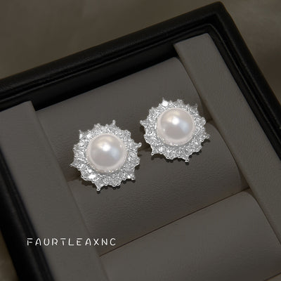 Silver pearl starburst halo studs in gray jewelry box