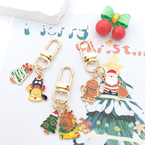 Three Christmas dual enamel charm keychains with Santa cats trees on card