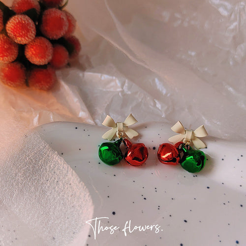 Ivory bow red green bell earrings on speckled plate