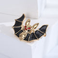 Black Wing Bat Brooch with Gold Tone Body and Red Eyes view 4