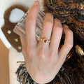 Gold Tone Openwork Ring With Red Oval Crystal Centerpiece view 2