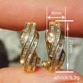 Gold Tone Twisted Baguette Stone Huggie Hoop Earrings view 4