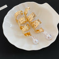 Sculpted Gold Pearl Drop Earrings in Polished Statement Design view 6