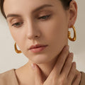 Irregular Rounded C Hoop Earrings in Polished Gold Tone view 1