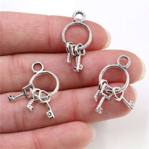 Finish comparison of mini key ring charms with three dangling keys in four finishes