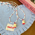Red and White Seed-Bead Necklace with Resin Apple-Core Pendant view 2