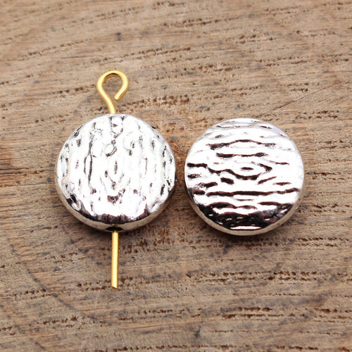Antique Bronze, Antique Silver, Antique Gold textured round small hole beads in three finishes shown in detail view