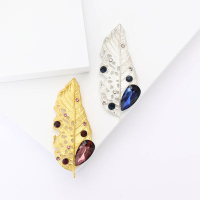 Front view of textured leaf with small stones and a large colored beetle body accent