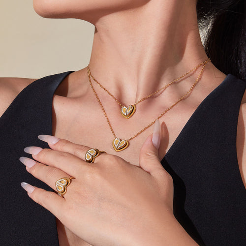 Model wearing gold heart zircon necklaces and open rings