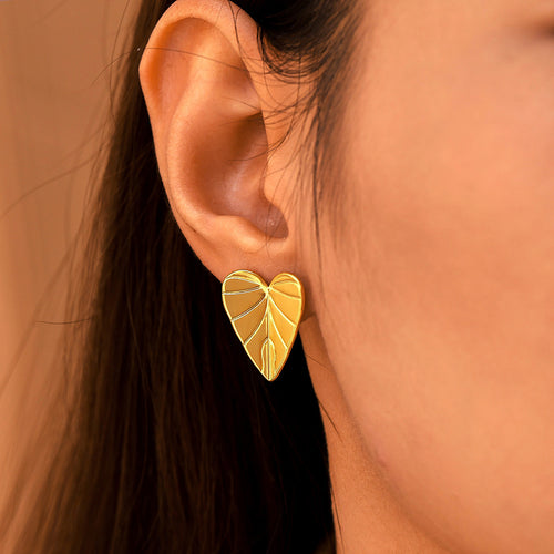 Gold heart leaf texture stud earring worn close-up