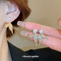 Gold Tone Mermaid Tail Stud Earrings With Pearl Accents view 1