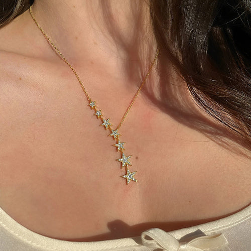 graduated star pendant necklace in two finishes shown from a side angle