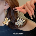 Crinkled Metal Flower Charm Hoop Earrings in Gold and Silver view 1